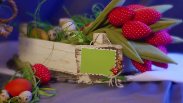 Slide Show Card is Put Near a Bunch of Red Tulips and Several Easter Hen and Quail Eggs on a Round Table