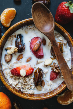 Closeup of a bowl of healthy cereal with fruit and nuts