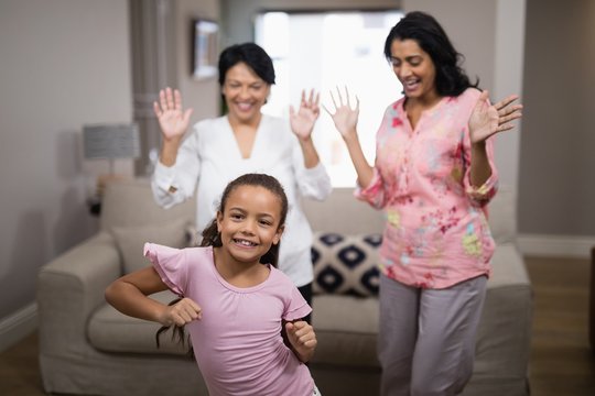 Portrait of smiling girl dancing with family