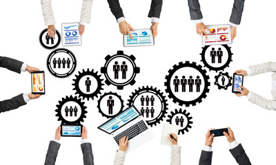 Top view of businesspeople sitting at table and using gadgets