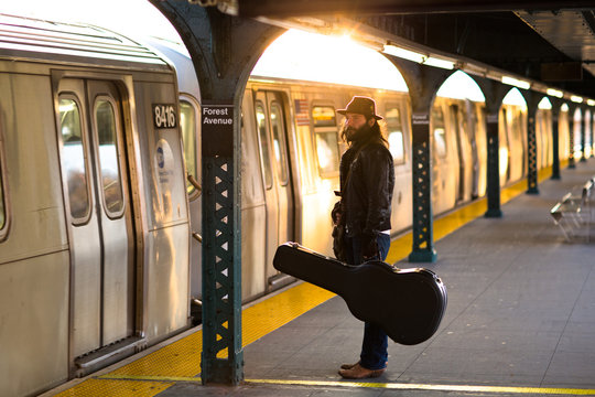 A musician waits patiently for the NYC Subway 