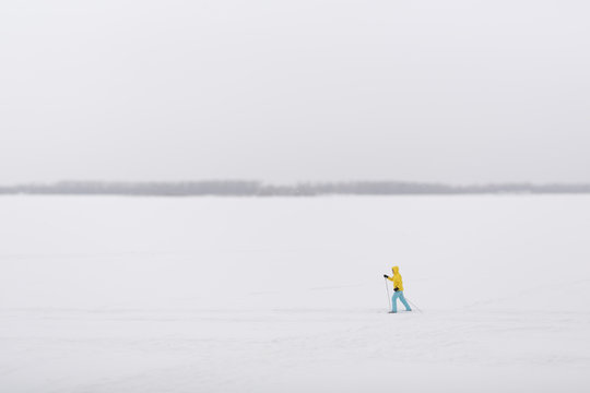 Skier moving on the frozen river 