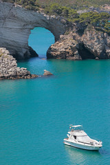 Yacht anchored in front of San Felice arch, Vieste, Gargano, Apulia, Italy