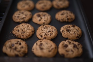 High angle view of baked cookies on black tray