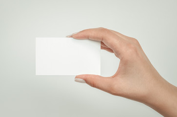 Fototapeta premium female hand holding blank white card. About us template