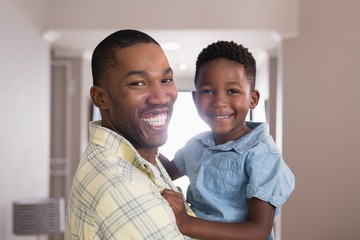 Happy father and son in living room at home