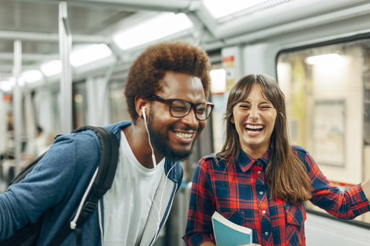 Friends having fun on a subway train