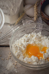 Fresh dairy products. Milk, cottage cheese, sour cream, fresh eggs and wheat on rustic wooden background.