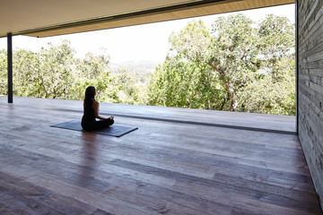 Woman meditating on yoga deck