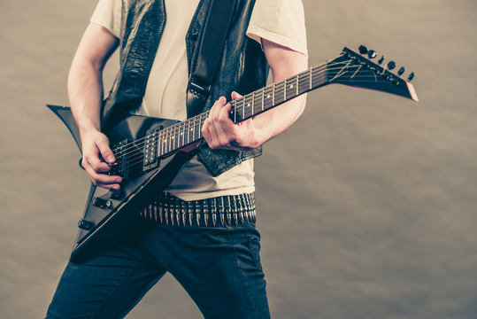 Male hands playing electric guitar