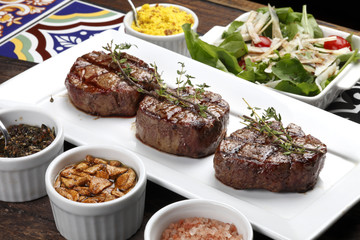 Three steaks roasted on the grill
