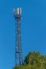 Technology on the top of the telecommunication GSM. Masts for mobile phone signal. Tower with antennas of cellular communication on the background of blue sky.