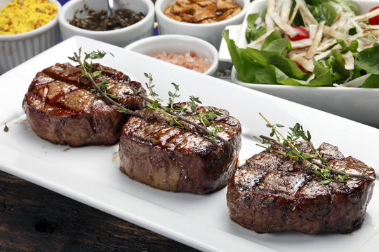 Three steaks roasted on the grill