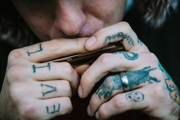 Close up of harmonica players hands