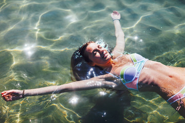 Young woman floating in the sea