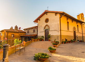 A church in a square of the town of Castagneto Carducci in Tuscany, Italy