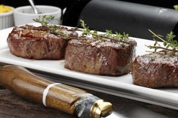 Three steaks roasted on the grill