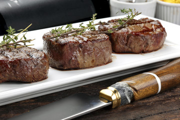 Three steaks roasted on the grill