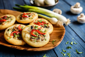 Baked small mushroom pies with cheese and pepper
