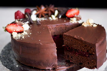 The chocolate cherry cake, decorated with strawberries, biscuits and strawberry shortcake.A masterpiece of culinary art