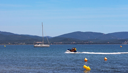 Fototapeta na wymiar Water scooter and sailing boat