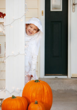 Halloween Boy Standing On Porch As Mummy