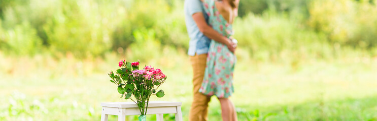 Happy Romantic couple hugging. Focus on flowers. selective focuse