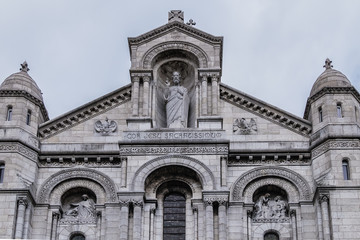 Fototapeta na wymiar Detail of Basilica Sacre Coeur (designed by Paul Abadie, 1875 - 1914) - Roman Catholic church and minor basilica, dedicated to Sacred Heart of Jesus. Paris, France.