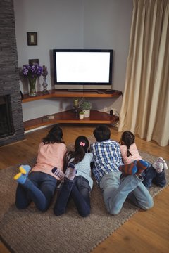 Family Watching Television Together In Living Room