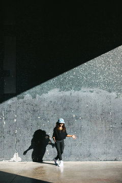 Young african american woman performing break dance in a city