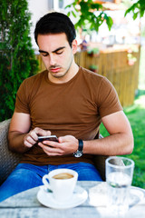 Young man sitting and using cellpohone