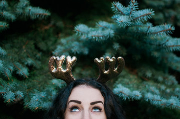 A young woman wearing reindeer ears