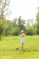 Fototapeta premium Portrait of the young beautiful romantic woman in dress outdoors