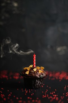 Chocolate cake with a single blown out candle