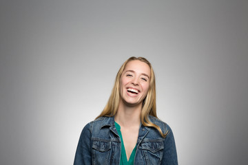 studio portrait of a young woman laughing