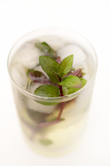 Kentucky derby drink in a glass goblet on a light background.