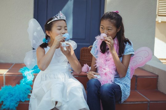 Siblings in fairy costume having a tea party - Powered by Adobe