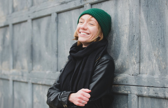 Young woman laughing and looking away from camera