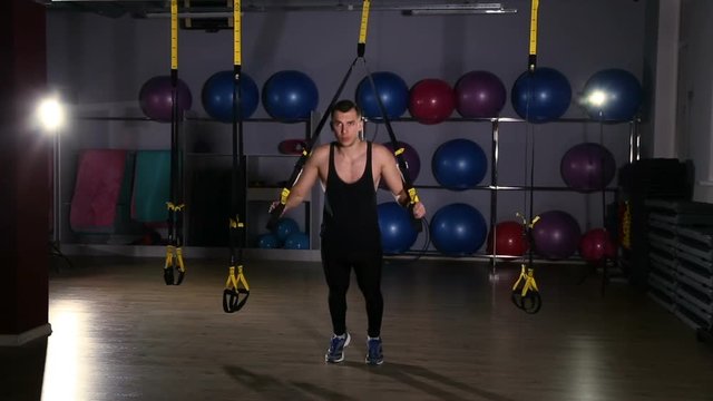 Man working out on trx in a gym