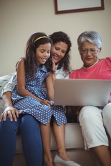 Happy family using laptop in living room