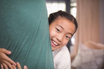 Smiling daughter hugging her father in living room