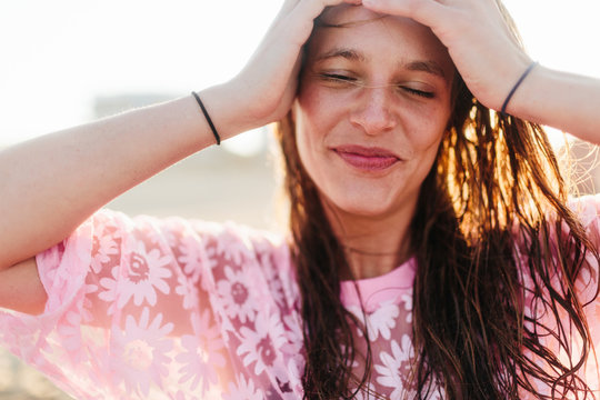 Happy young woman coyly smiles 