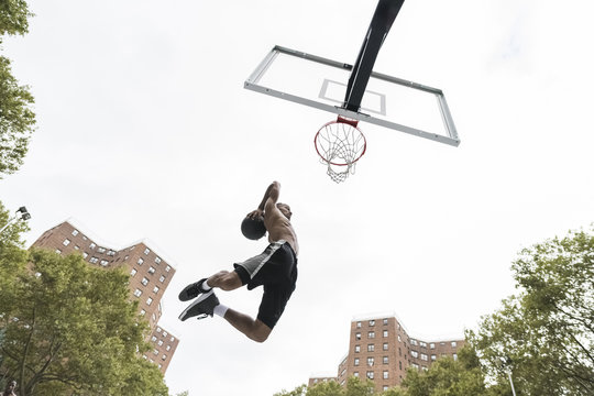 Young man playing basketball outdoors