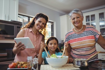 Happy family preparing food in kitchen