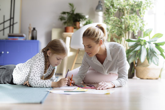 Girl Drawing With Her Mother