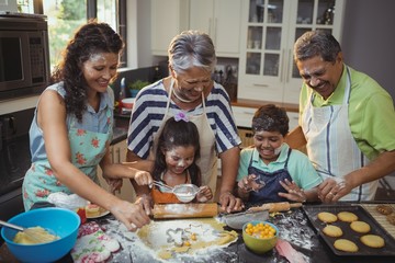 Happy family preparing dessert in kitchen