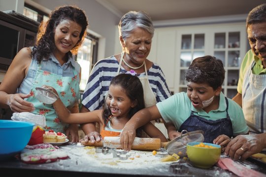 Happy family preparing dessert in kitchen