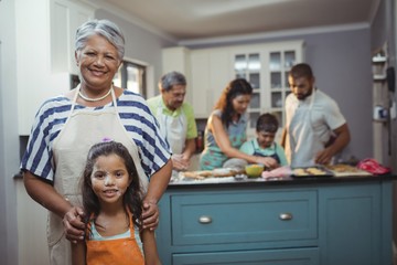 Family members preparing dessert in background