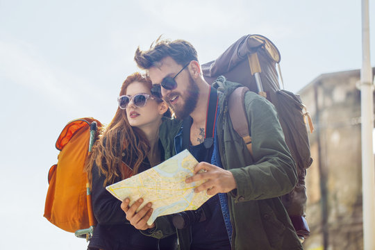 Tourists Looking for Places on a Map