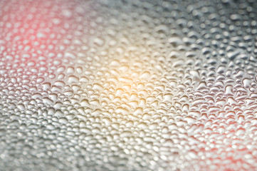 Macro texture drops on the plastic of the background.